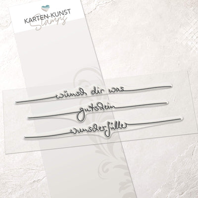 Clear Stamp Set mit den handschriftlichen Schriftzügen „wünsch dir was“, „gutschein“ und „wunscherfüller“ auf transparenter Trägerfolie, ca. 13 cm breit.
